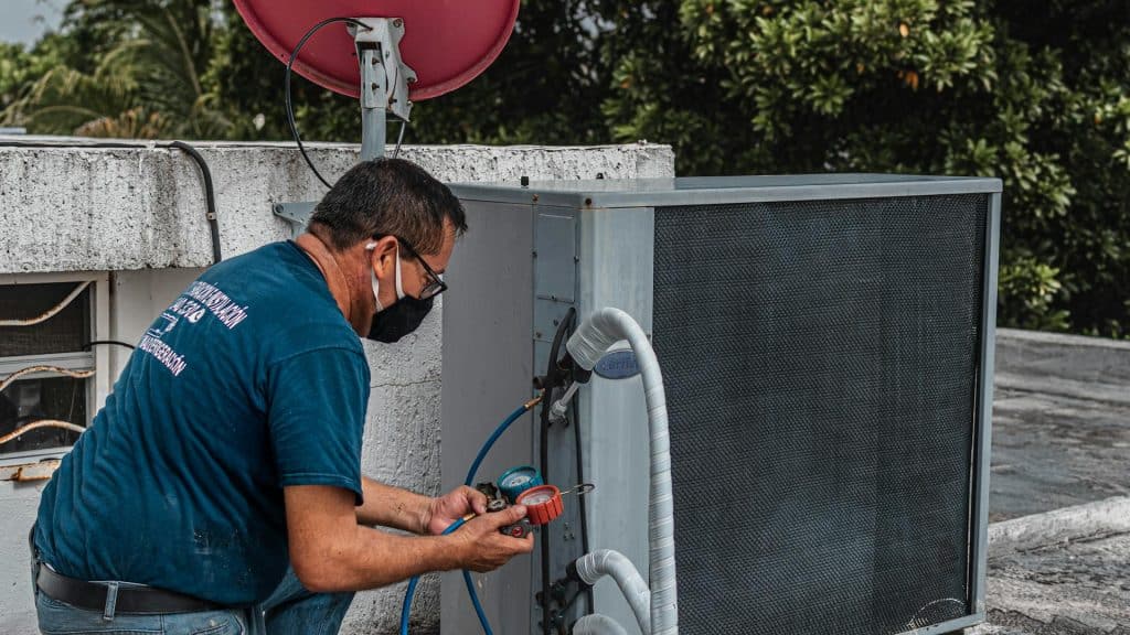 Technician servicing an air conditioning unit